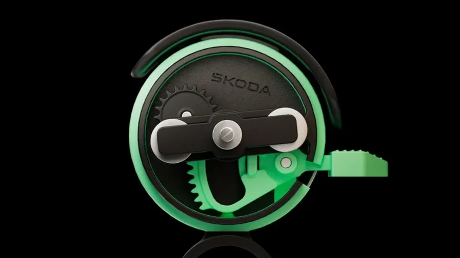 A Škoda DuoBell csengő belső kalapácsmechanizmusa, zöld fogaskerékkel
